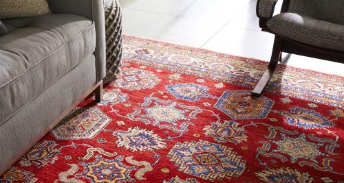 Traditional-style rug under a sofa leg and chair leg